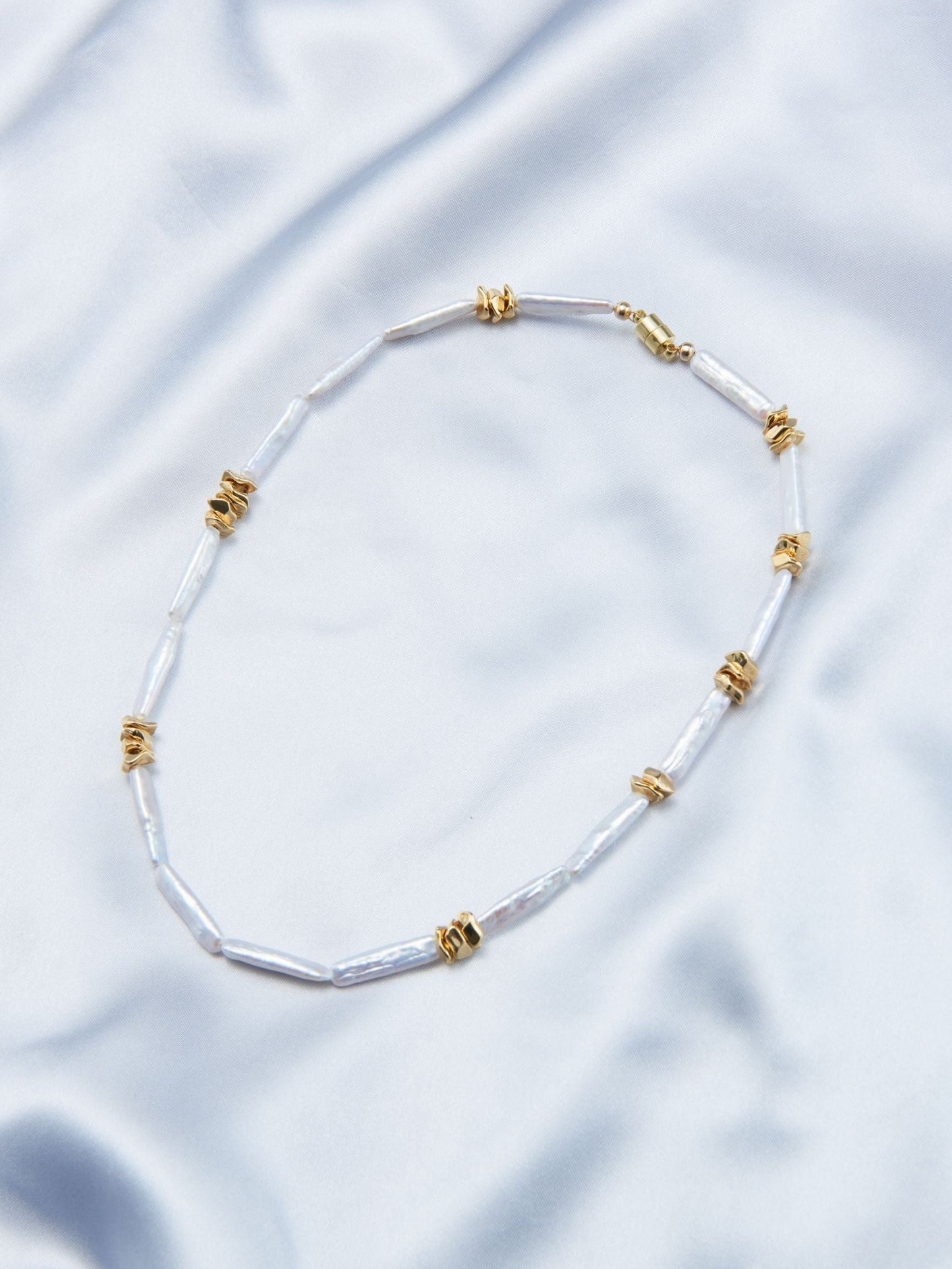 Handcrafted baroque pearls necklace featuring unique irregular shapes and a golden clasp