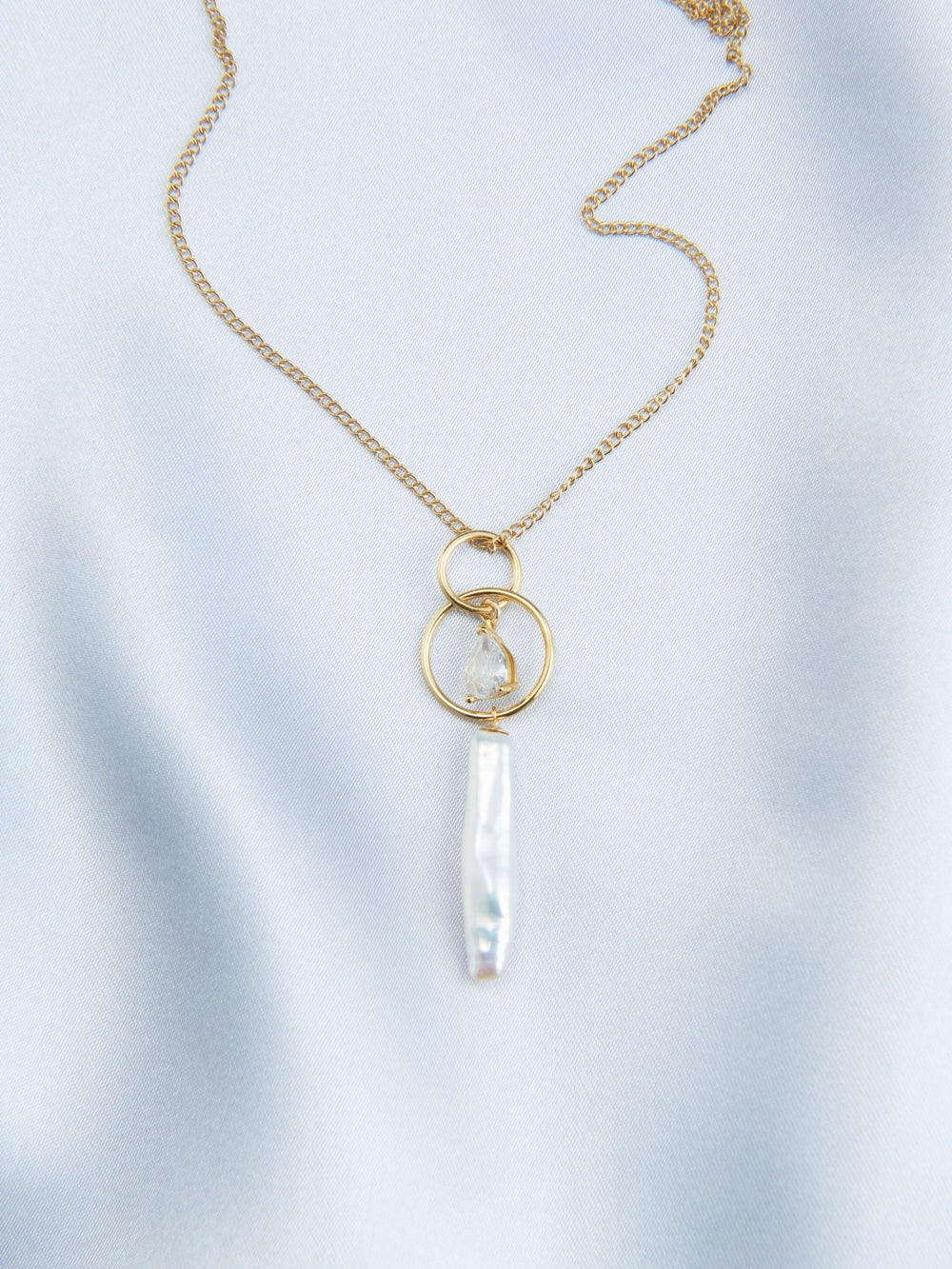 Elegant baroque pearl drop necklace with gold chain and unique pendant design