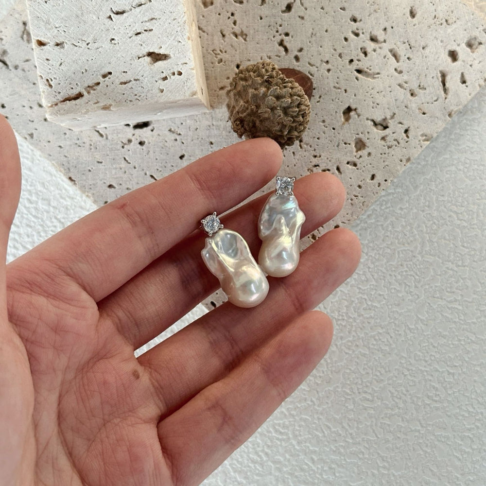 
                      
                        Baroque pearl earrings with sparkling accents showcasing unique organic shapes and elegant design
                      
                    