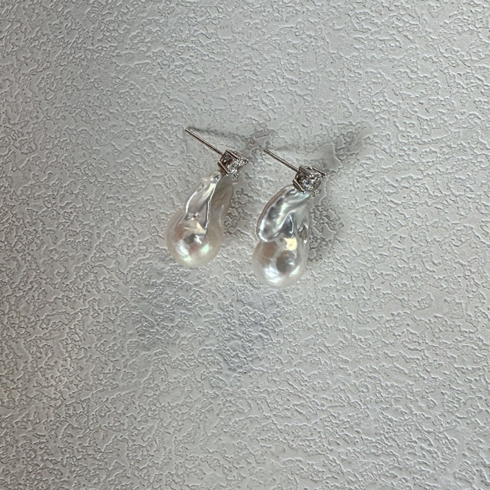 
                      
                        Baroque pearl earrings with elegant silver accents for stylish jewelry lovers
                      
                    