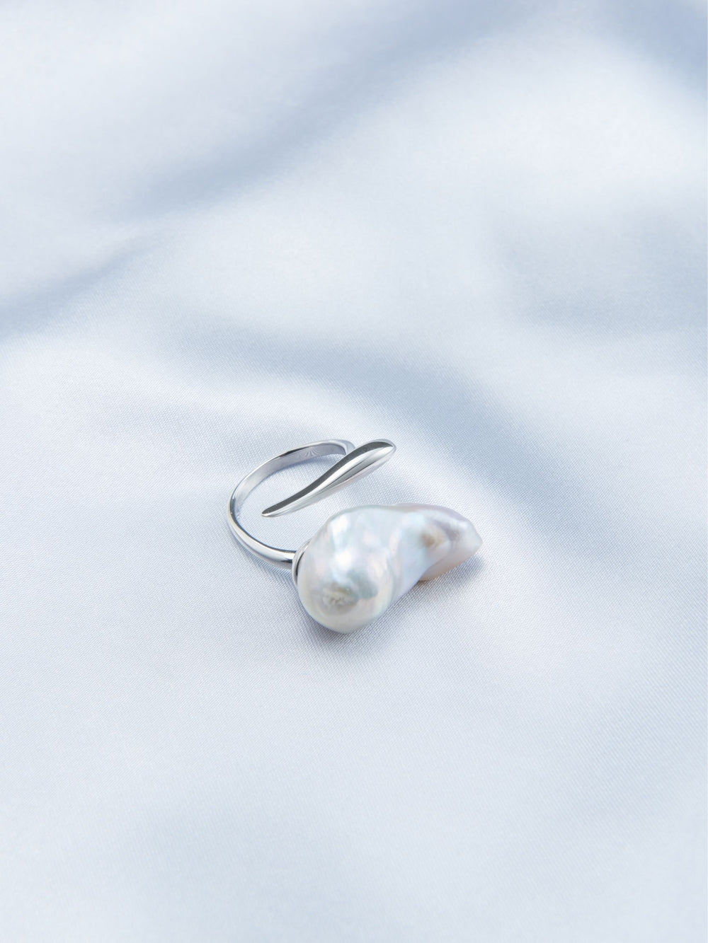 Elegant bold baroque pearl ring with a silver setting featuring a unique organic shape
