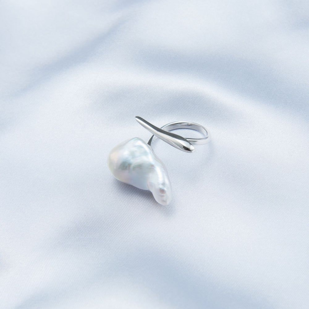 
                      
                        Bold baroque pearl ring with unique shape, set on a smooth silver band for a striking jewelry statement
                      
                    