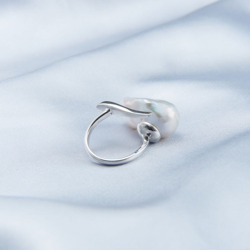 
                      
                        Elegant bold baroque pearl ring displayed on soft fabric background, showcasing its unique design
                      
                    