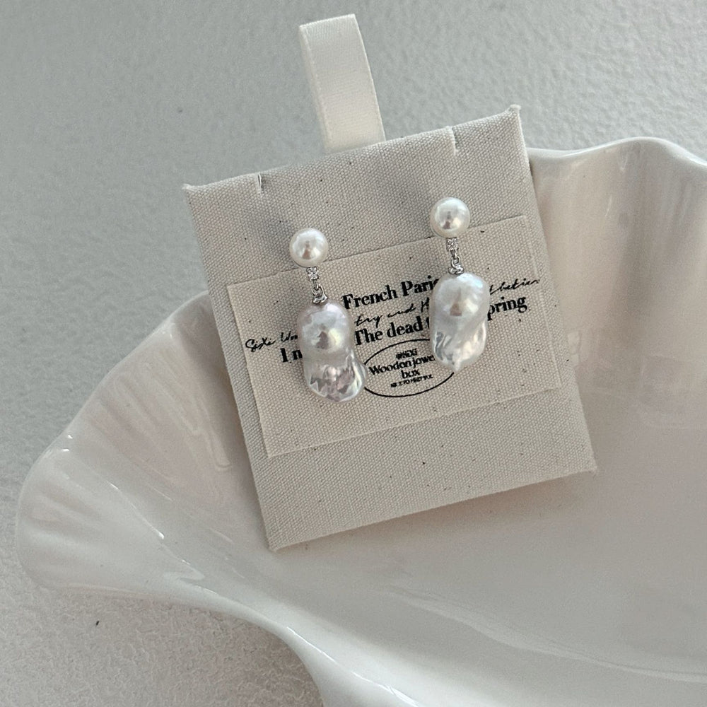 
                      
                        Elegant pearl accessories featuring unique drop earrings with lustrous pearls from Pearlra
                      
                    