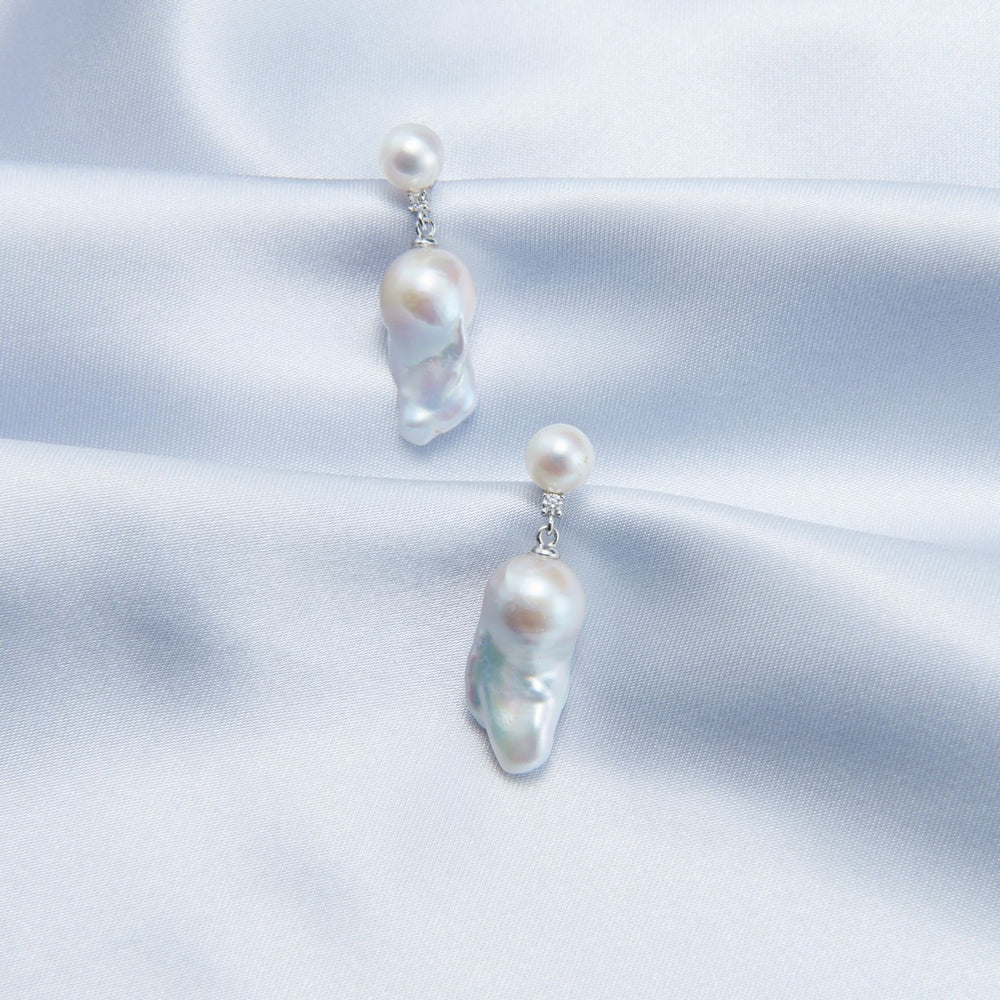 
                      
                        Elegant pearl accessories featuring unique baroque pearl earrings with silver accents
                      
                    