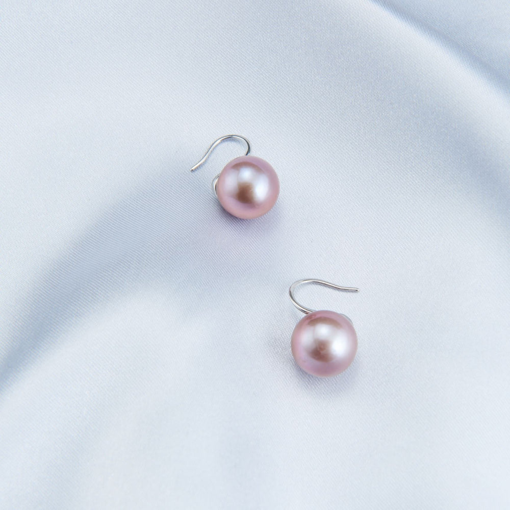 
                      
                        Elegant pearl earrings with soft pink hues, perfect for adding a touch of sophistication to any outfit
                      
                    