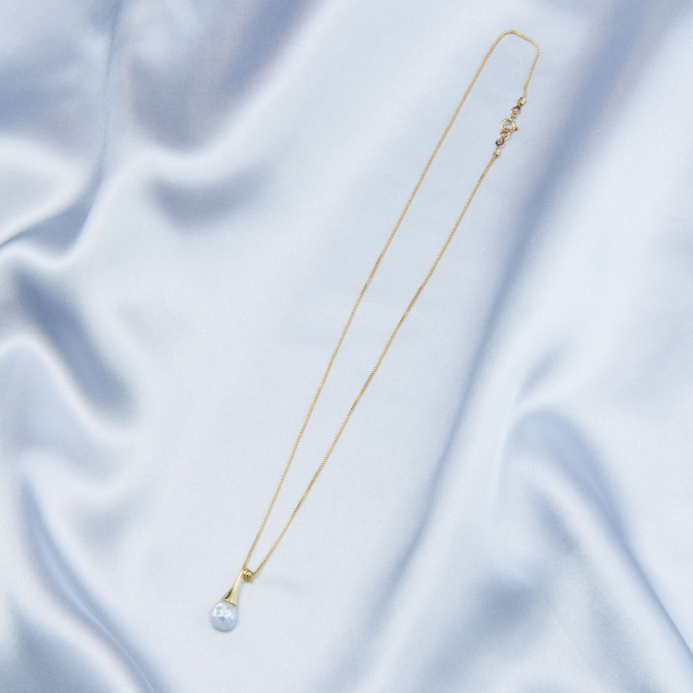 
                      
                        Elegant pearl pendant necklace from Pearlra on a soft, silky background for sophisticated styling
                      
                    