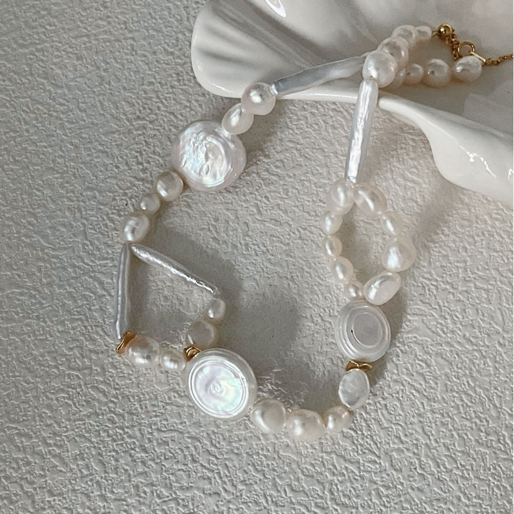 
                      
                        Elegant French baroque pearl necklace with unique shapes and glossy finishes, perfect for any occasion.
                      
                    