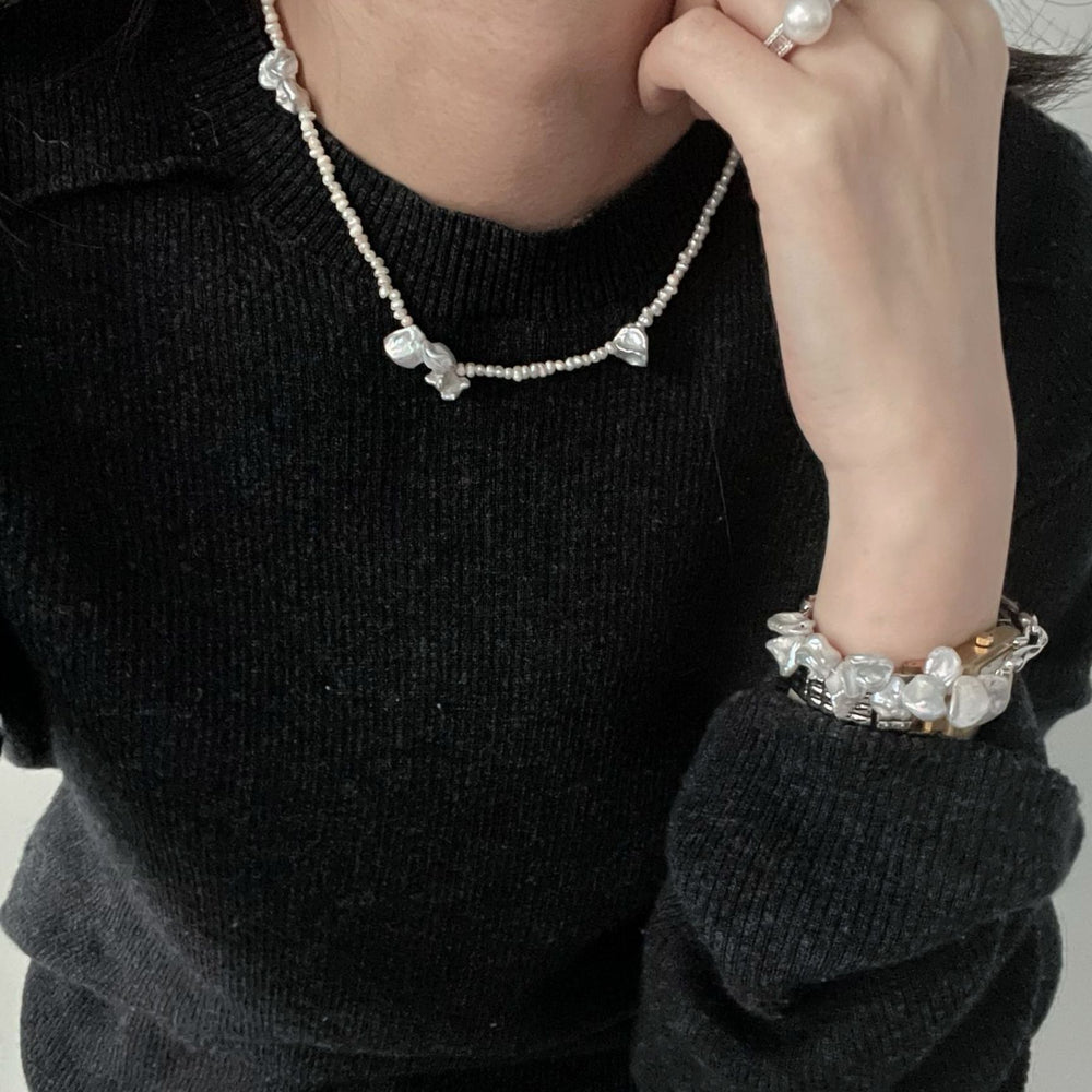 Stylish handcrafted baroque necklace with natural pearls, layered with matching jewelry for a chic look