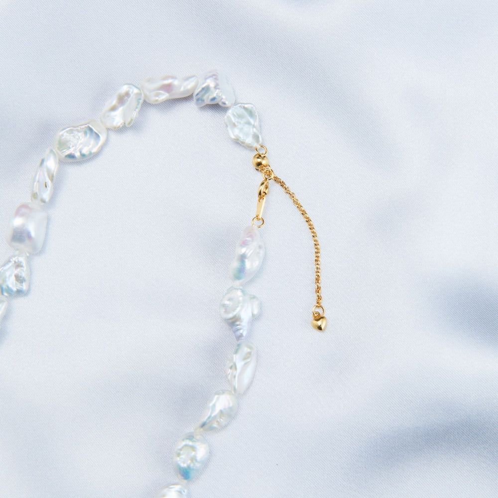 
                      
                        Elegant necklace featuring handcrafted baroque pearls with a delicate gold clasp
                      
                    