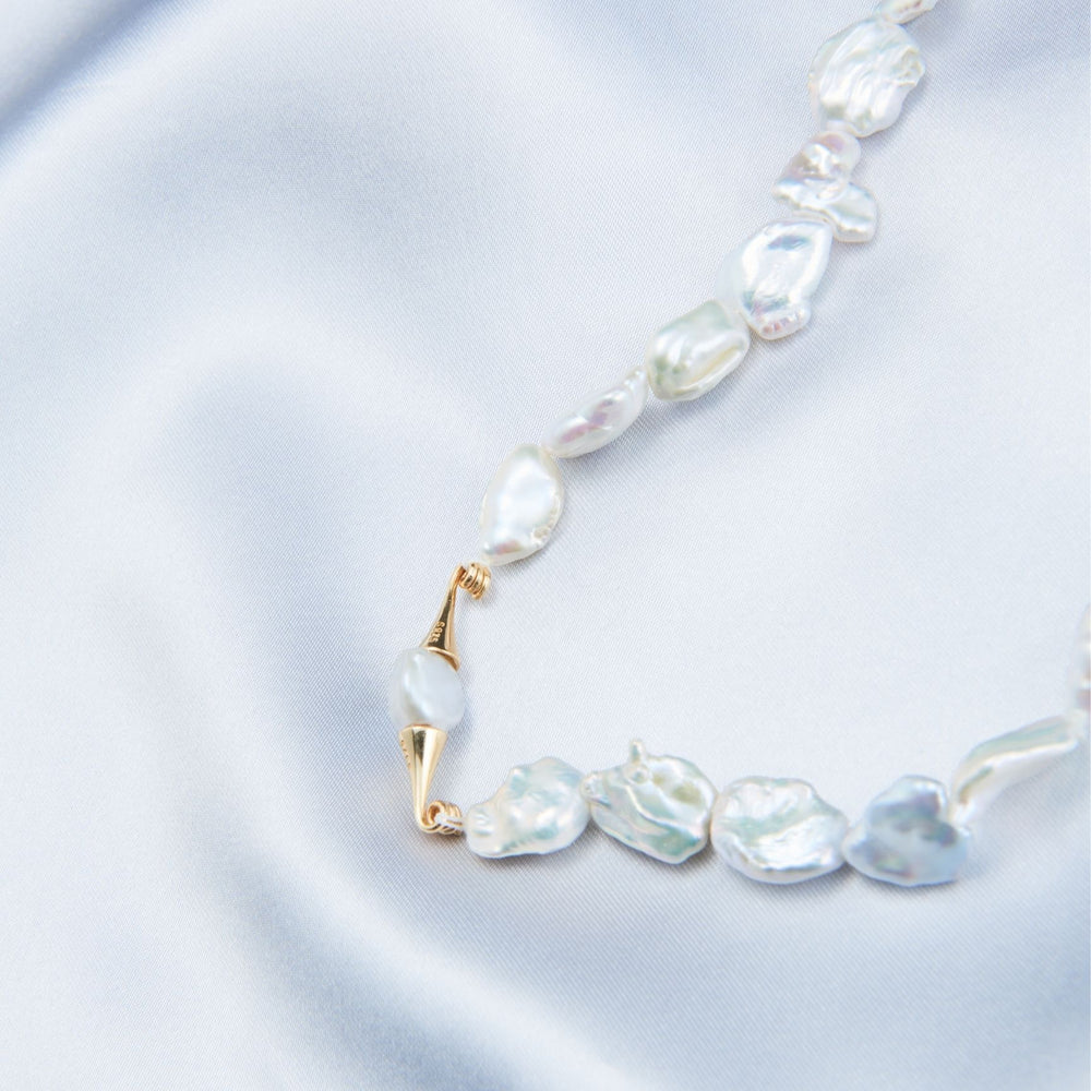 
                      
                        Elegant necklace featuring handcrafted baroque pearls and gold accents for a timeless look
                      
                    