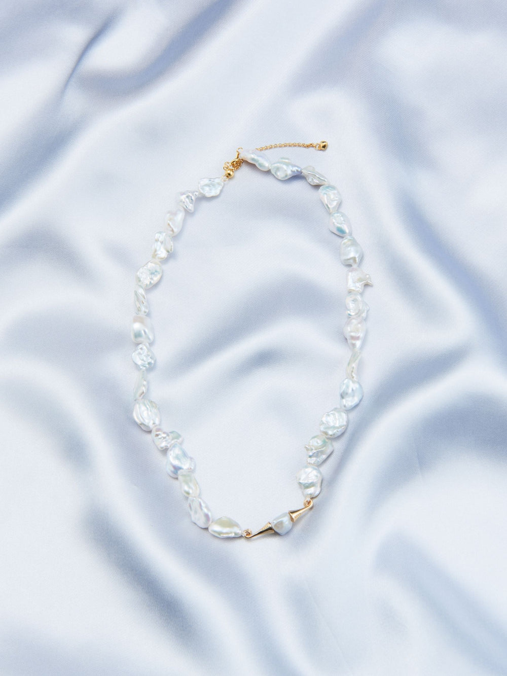 Handcrafted baroque pearls necklace featuring unique irregular shapes and a golden clasp