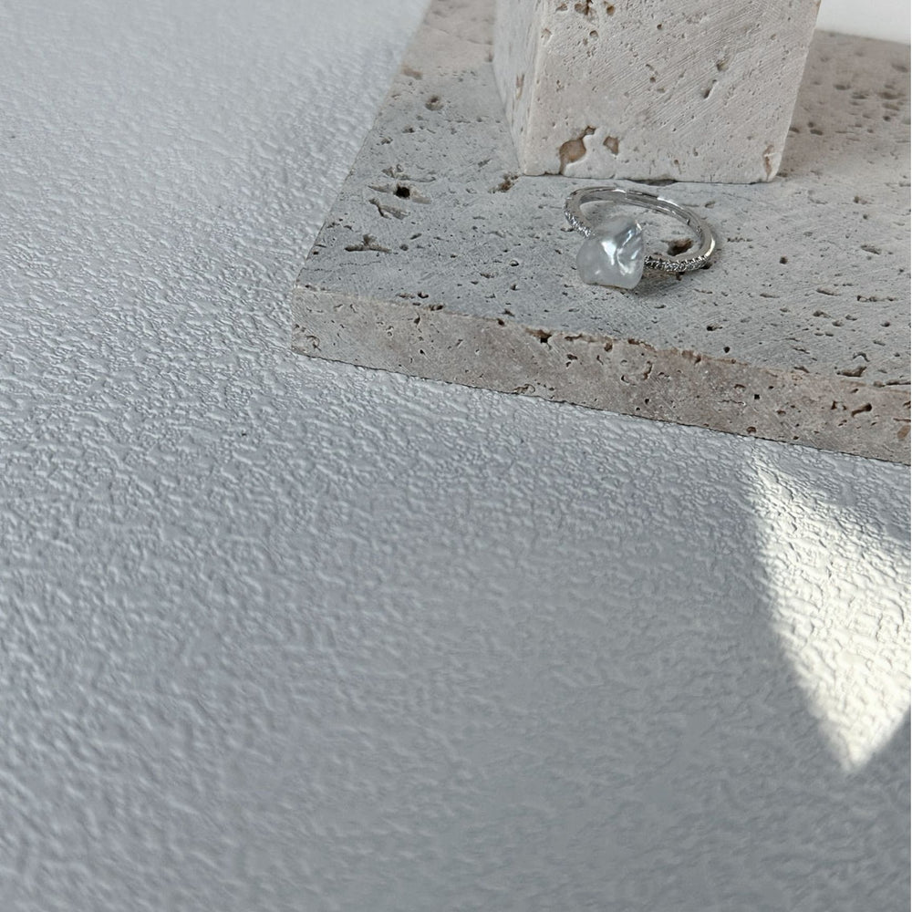
                      
                        Stylish handcrafted keshi pearl ring displayed on a textured surface with neutral tones
                      
                    