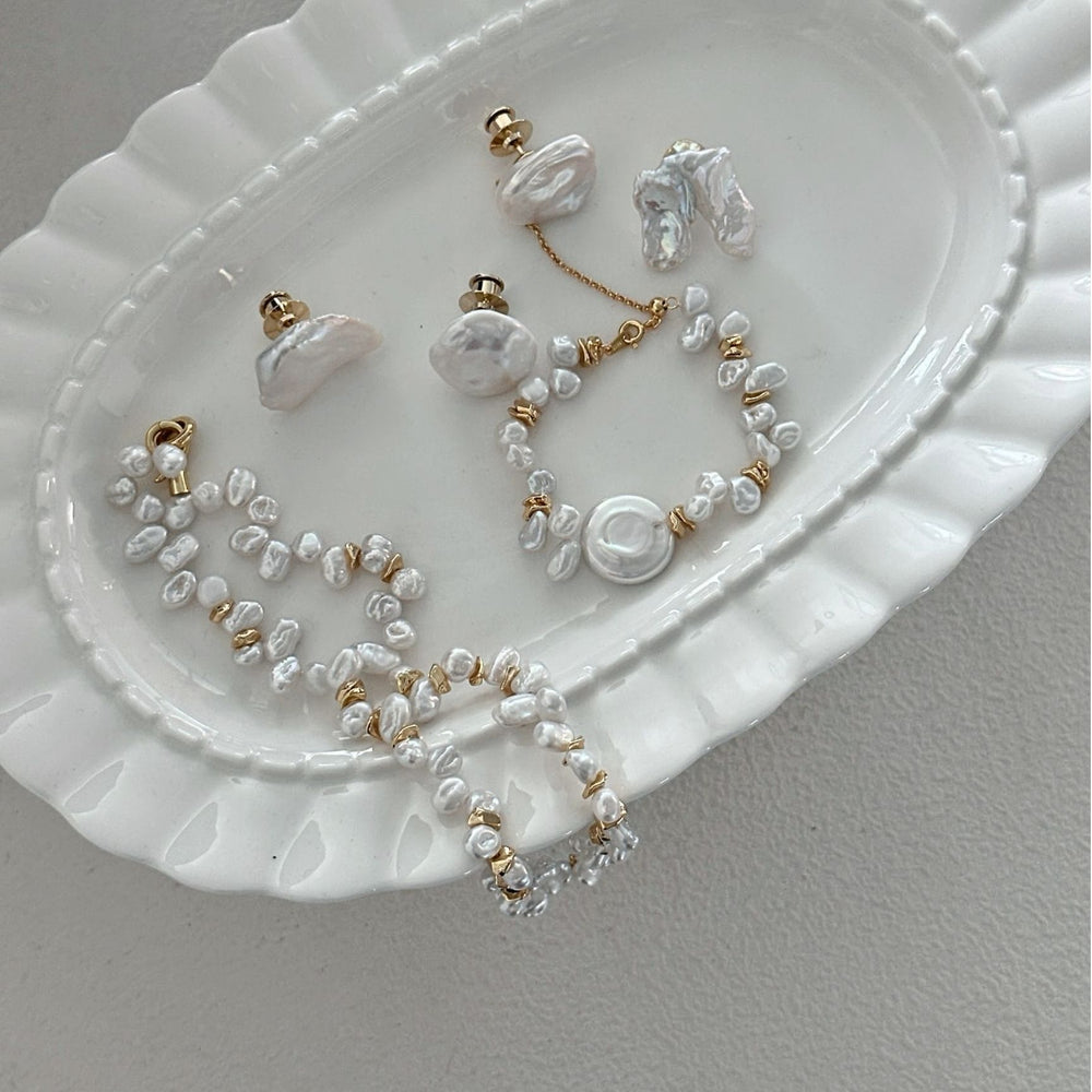 
                      
                        Handmade Keshi pearl necklace with matching earrings displayed on a decorative plate
                      
                    