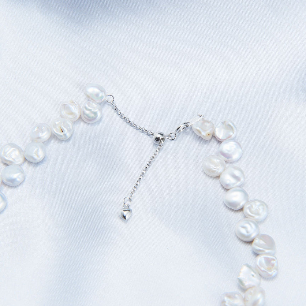 
                      
                        Handmade Keshi pearl strand necklace featuring unique pearls and a silver clasp
                      
                    