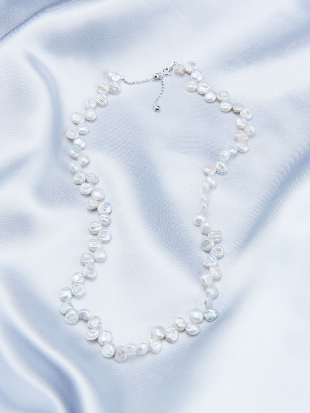 Handmade Keshi pearl strand necklace on soft satin fabric for elegant style