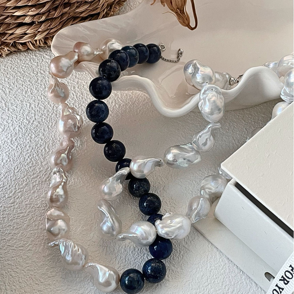
                      
                        Lapis lazuli Baroque necklace featuring unique baroque pearls for a luxurious style.
                      
                    