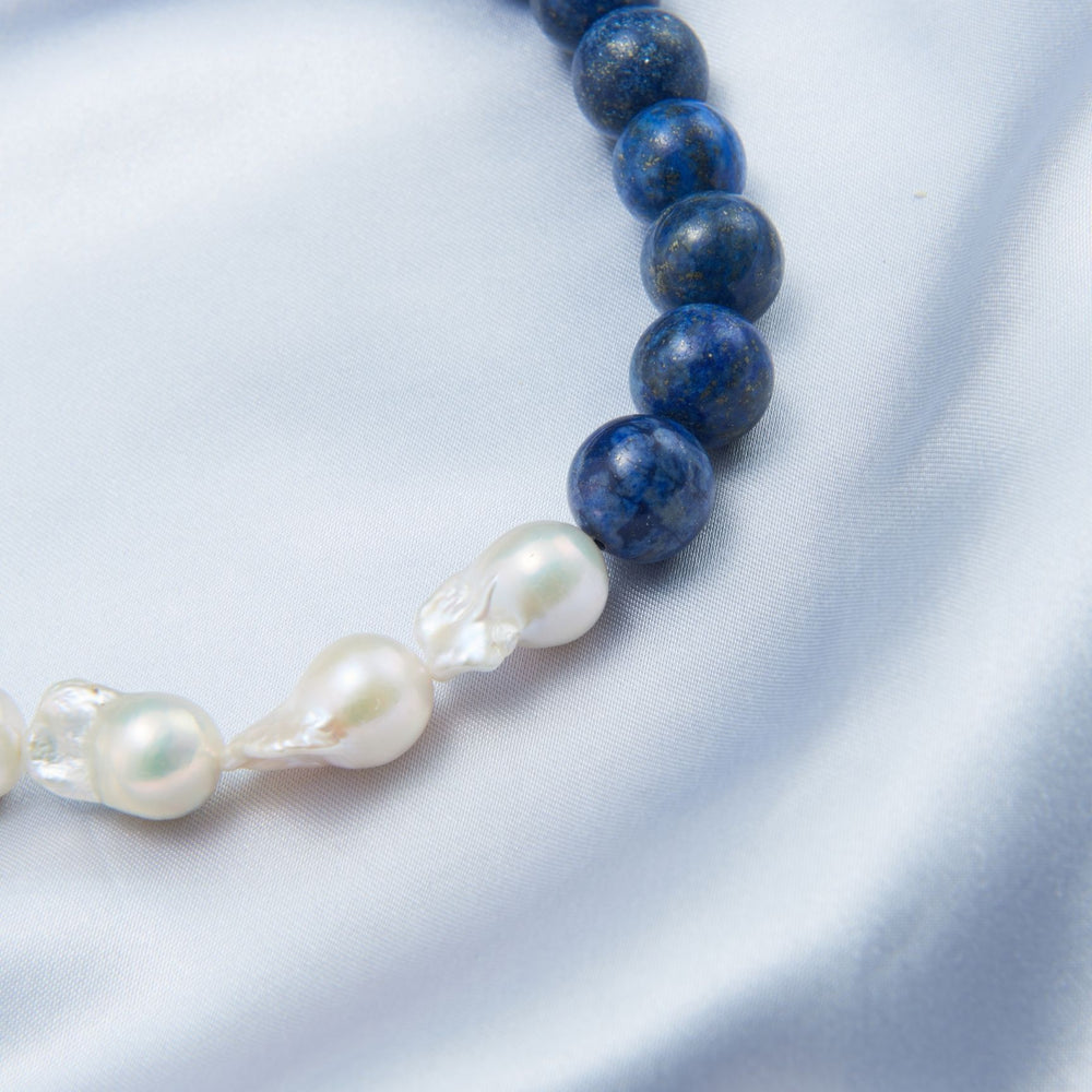 
                      
                        Lapis lazuli Baroque necklace featuring deep blue stones and elegant white pearls
                      
                    