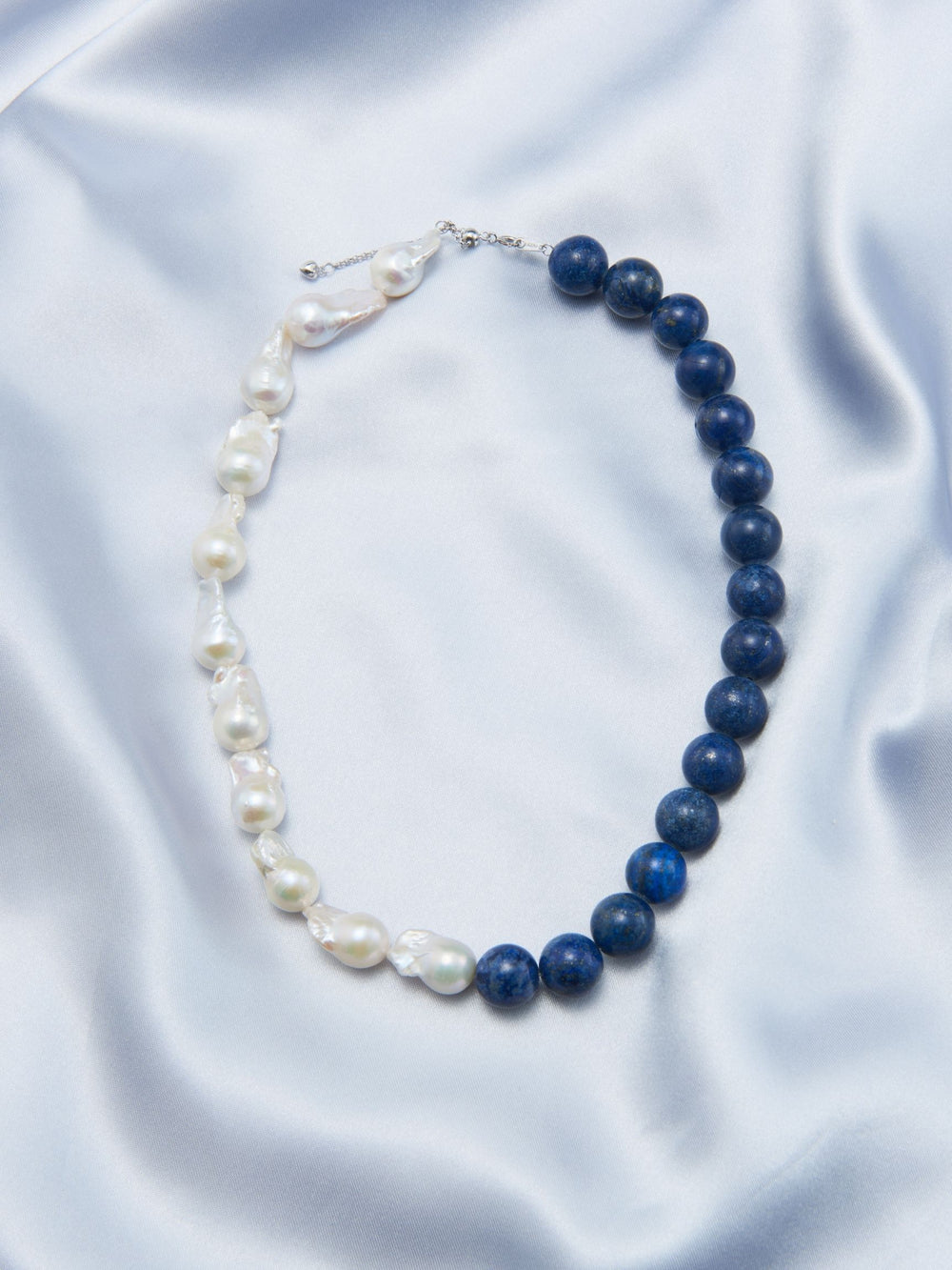 Lapis lazuli Baroque necklace featuring blue gemstones and lustrous pearls for elegant style