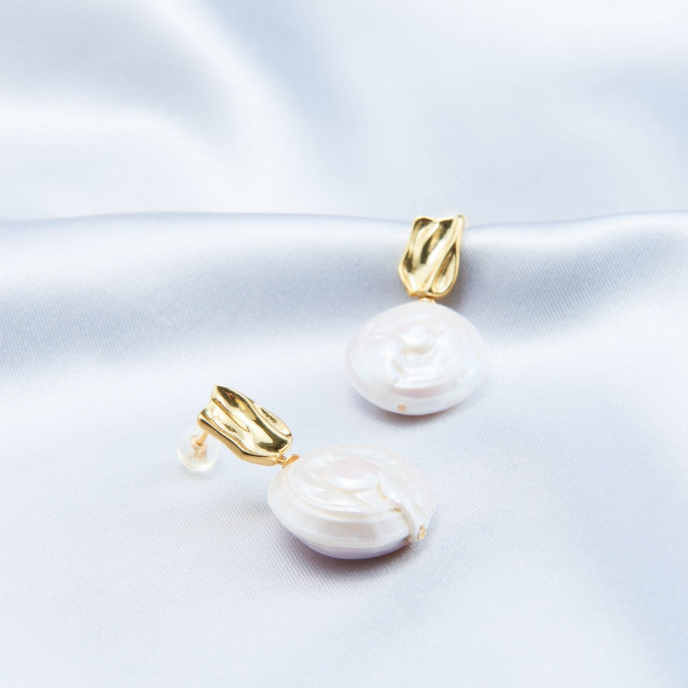 
                      
                        Elegant modern baroque earrings featuring gold accents and lustrous pearl design
                      
                    