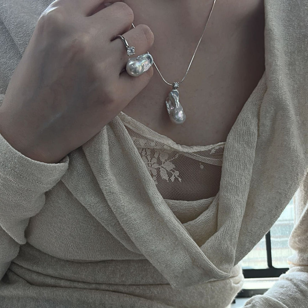 
                      
                        Model wearing a petite baroque pearl ring and matching necklace for elegant jewelry styling
                      
                    