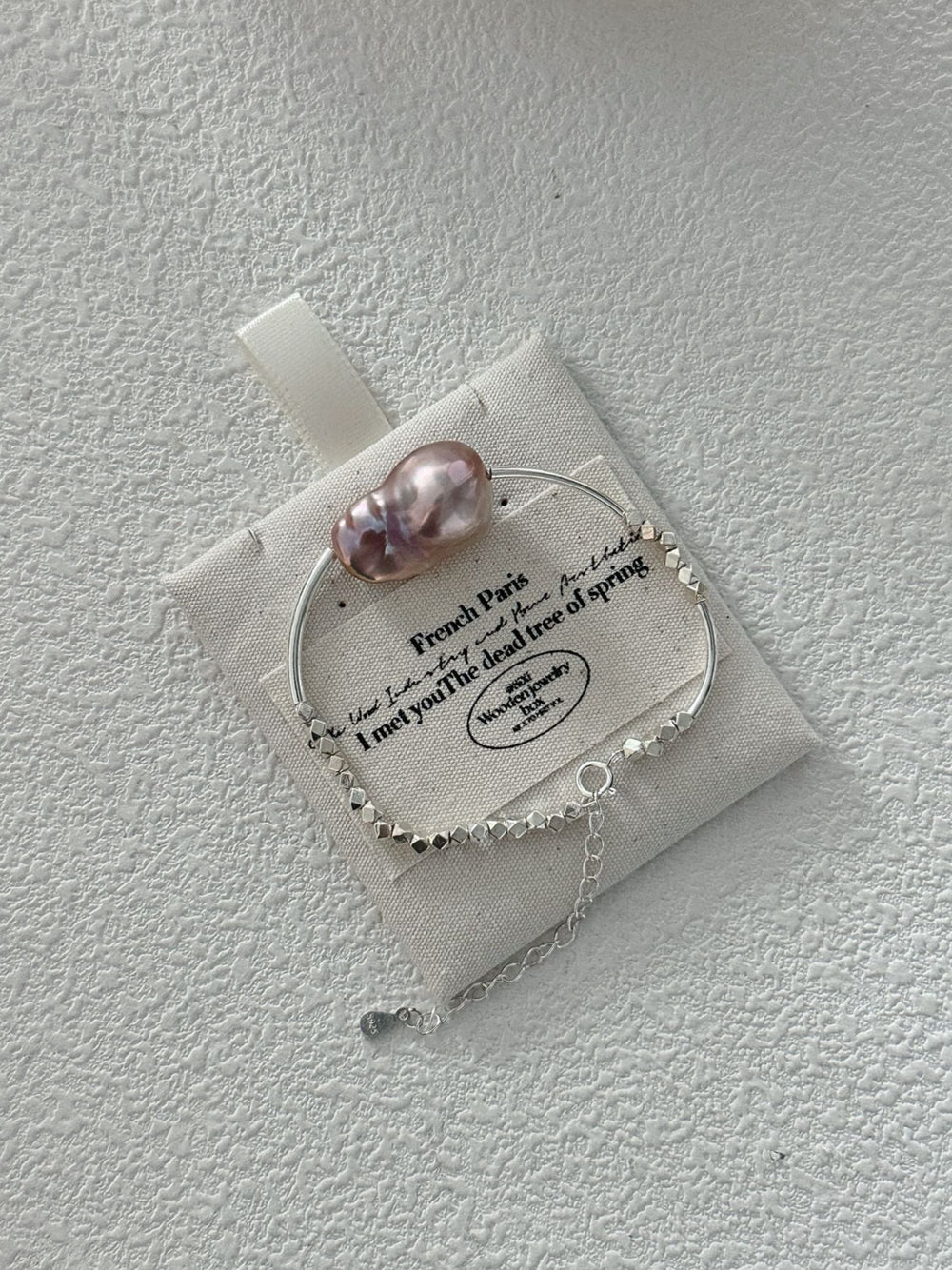 Sterling silver pearl bracelet featuring a uniquely shaped pink pearl and delicate chain detail