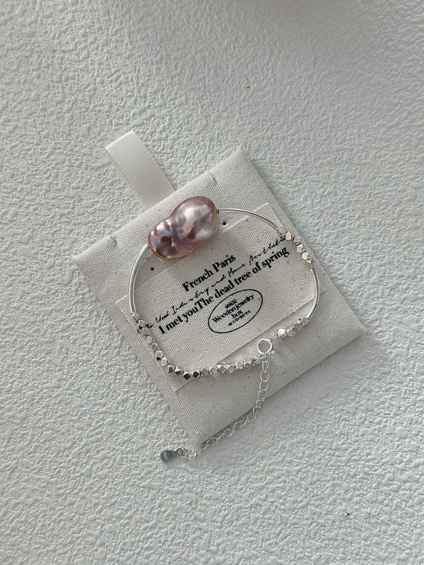 Sterling silver pearl bracelet featuring a uniquely shaped pink pearl and delicate chain detail
