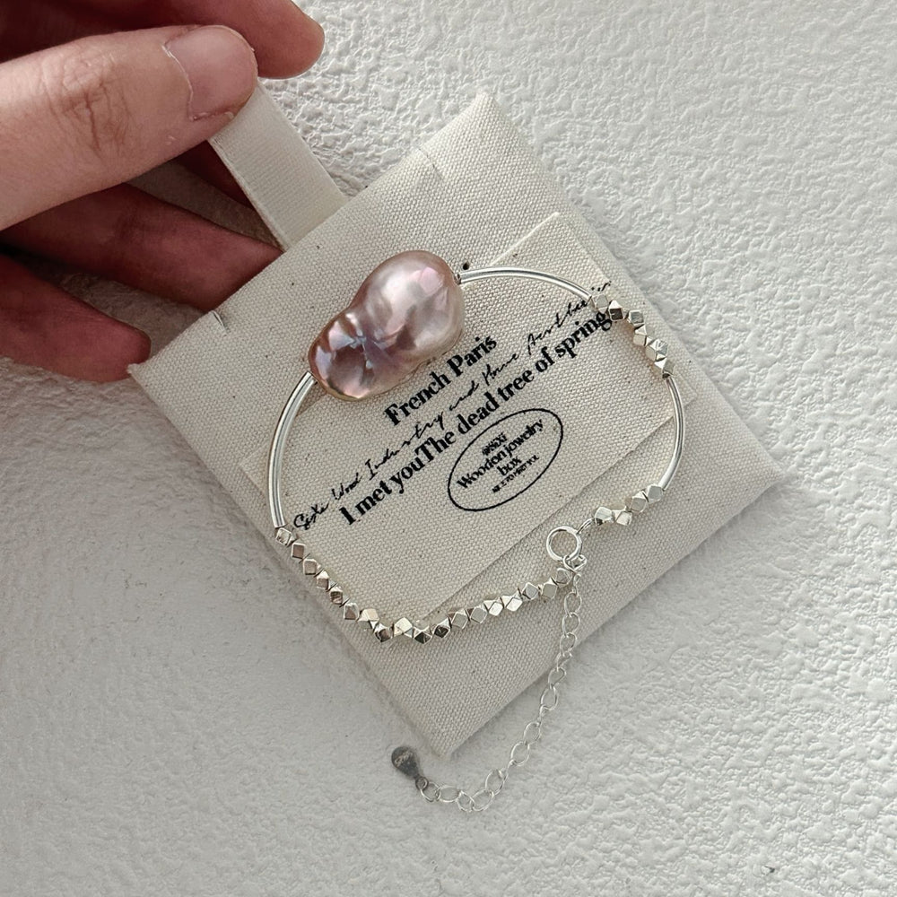 
                      
                        Handcrafted sterling silver pearl bracelet featuring a large baroque pearl and delicate silver accents
                      
                    