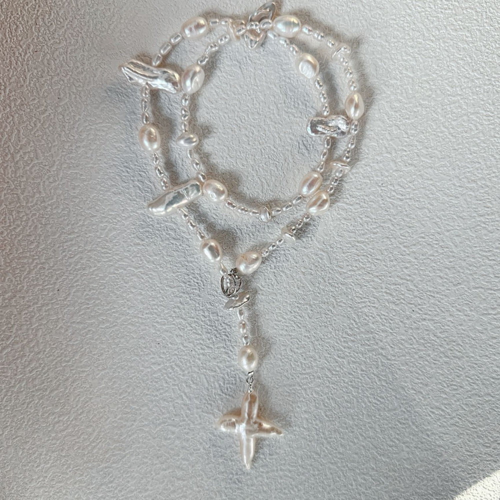 
                      
                        Stylish baroque cross pendant necklace with freshwater pearls and silver accents for elegant looks
                      
                    