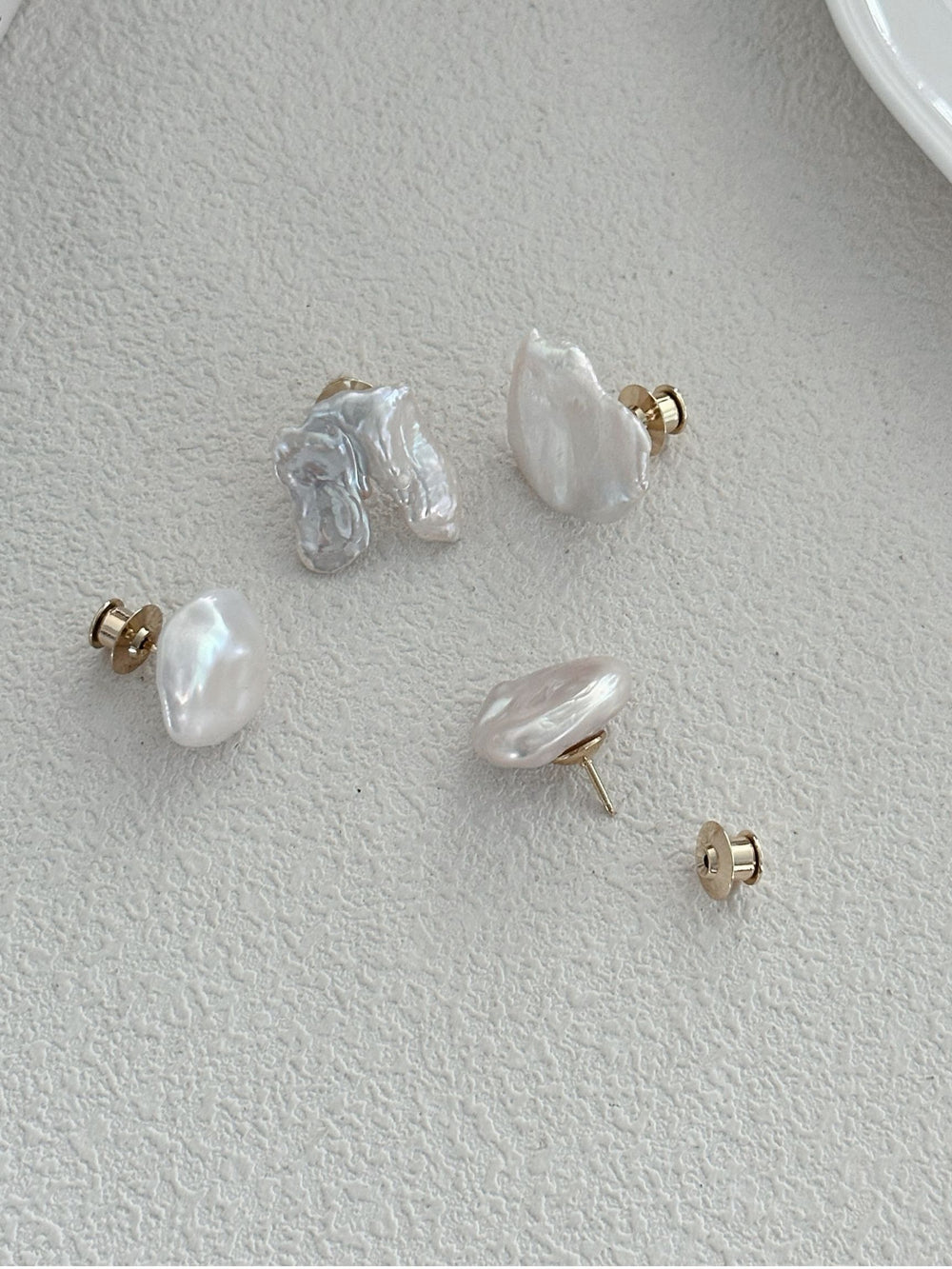 Unique baroque Pearl brooch set with natural shapes and a gold backing for elegant style