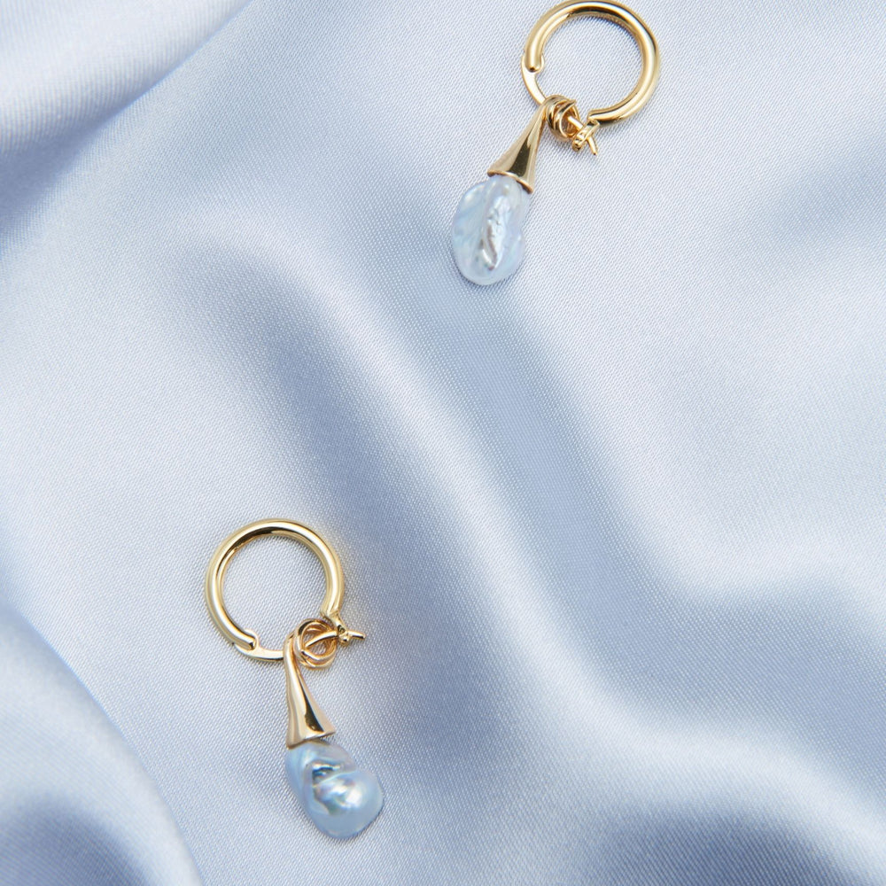 
                      
                        Unique pearl drop earrings by Pearlra with a captivating design featuring blue pearls
                      
                    