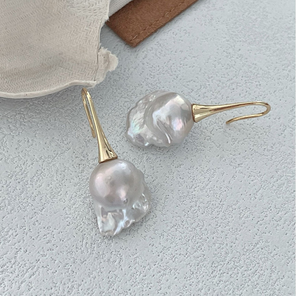 
                      
                        Pearlra 18K Gold Plated Baroque Pearl Stud Earrings with irregular shaped pearls on textured surface
                      
                    