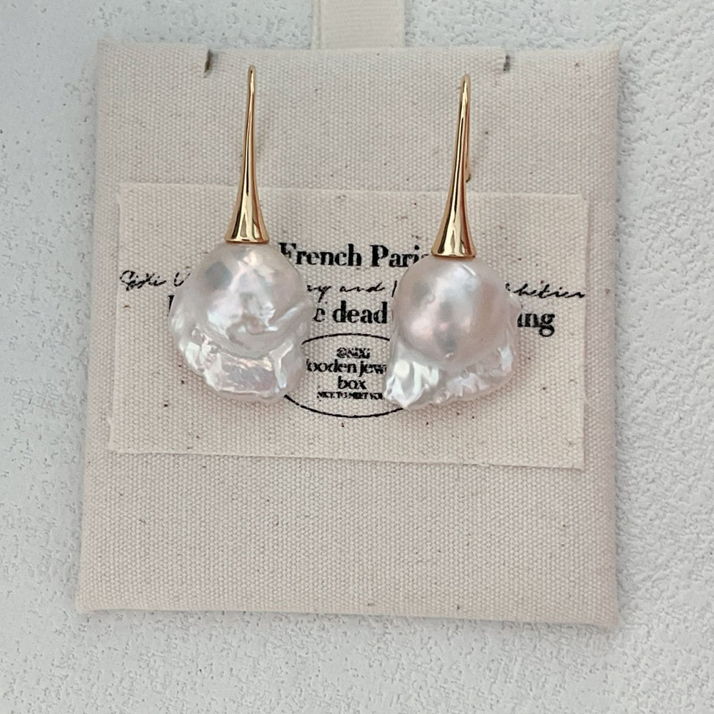 
                      
                        Pearlra 18K Gold Plated Baroque Pearl Stud Earrings displayed on beige fabric card
                      
                    