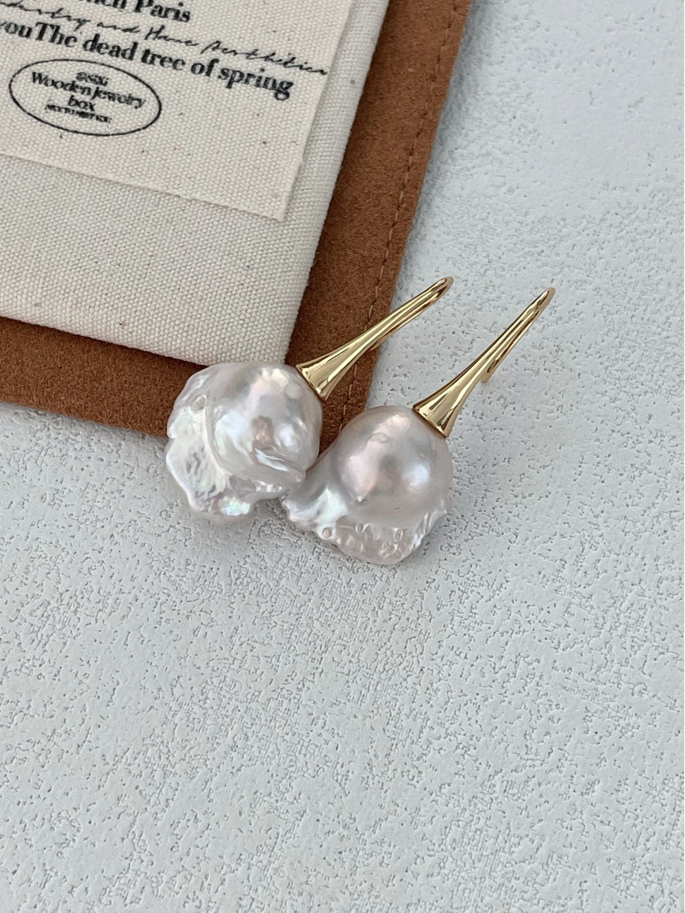 Pearlra 18K Gold Plated Baroque Pearl Stud Earrings with unique irregular pearls on textured surface